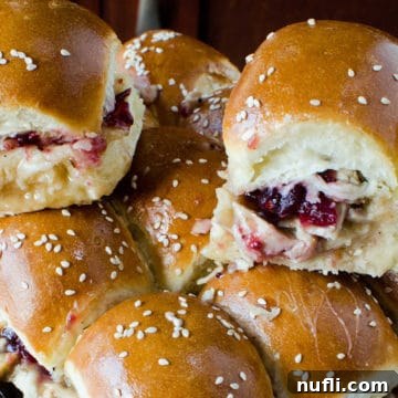 Stacked cranberry turkey sliders on a serving platter