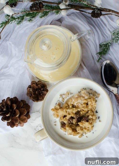 Slow Cooker Eggnog Oatmeal 3 Creamy Crock Pot Eggnog Oatmeal in a white bowl with a spoon, surrounded by festive pinecones and a pitcher of eggnog
