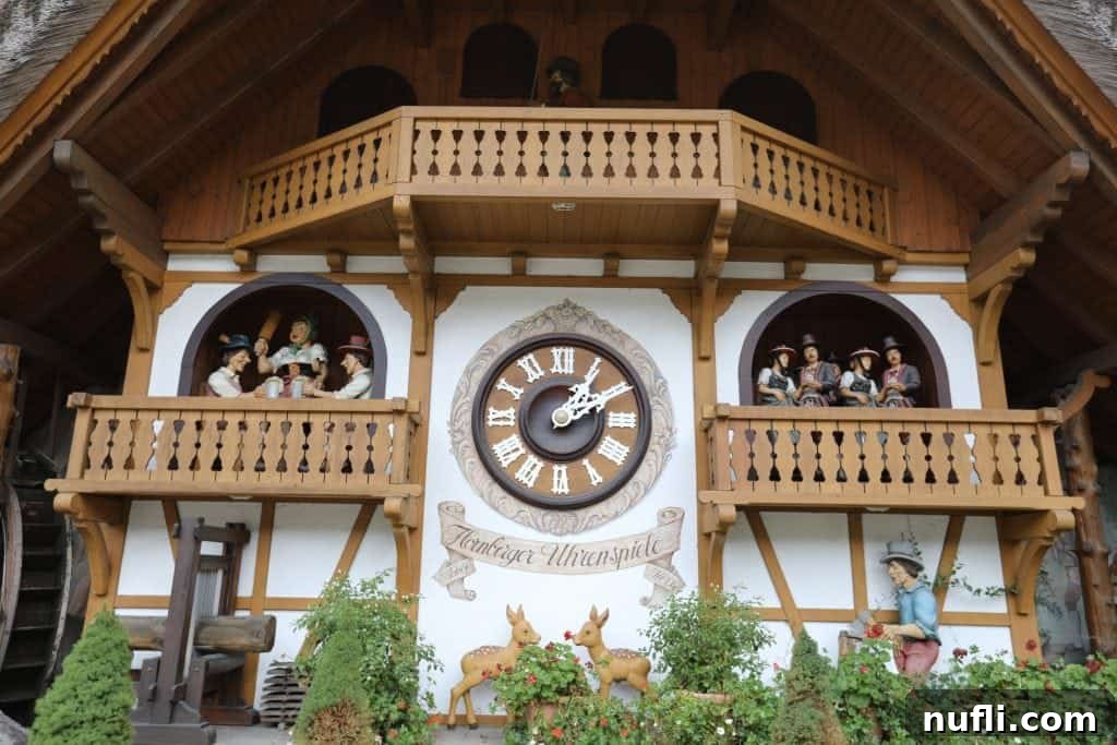 A charming giant cuckoo clock, adorned with intricate figurines, stands proudly outside a traditional German clock shop in the Black Forest.