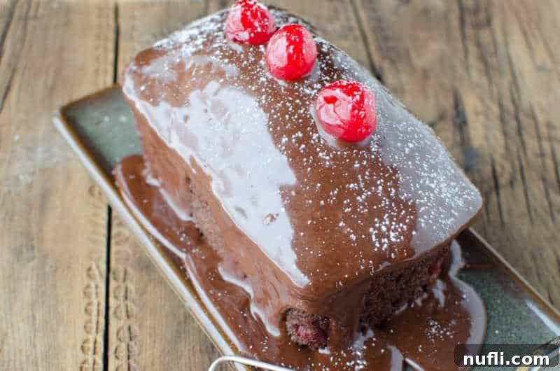 Mini black forest cake on a small tray with cherries on top of it, highlighting the dessert's appealing individual size