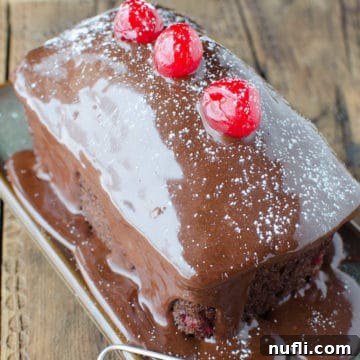 Mini Black Forest Cake garnished with maraschino cherries on a small plate, ready to be served