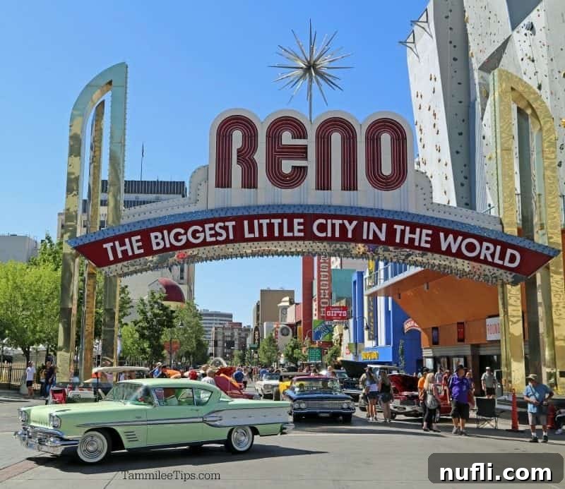 Hot August Nights Reno: The Classic Car Extravaganza 2 Classic cars driving under the Reno Sign