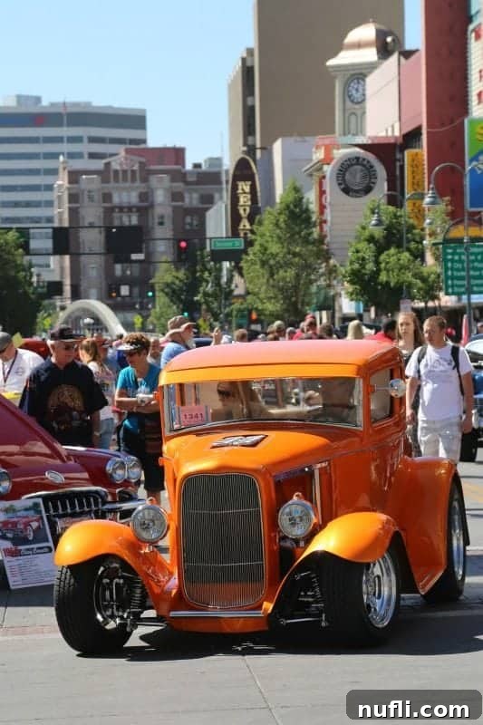 Hot August Nights Reno: The Classic Car Extravaganza 6 Orange classic car surrounded b people and other cars