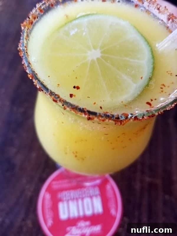 margarita with a spicy rim and lime wheel floating in it