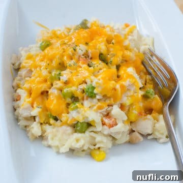 Chicken Orzo Casserole on a white plate with a fork