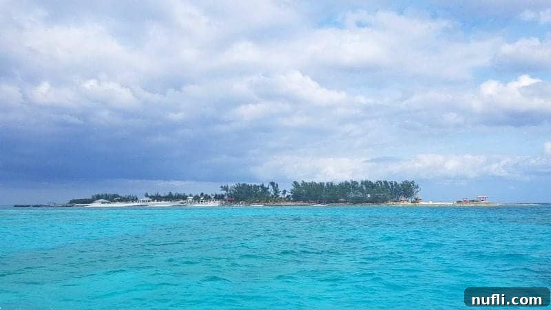 Expansive view of tropical island beach area seen over the clear blue water