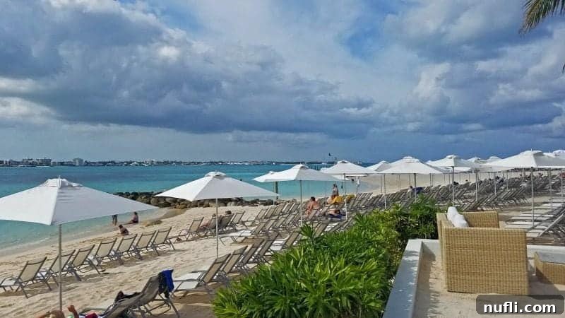 Serene view of lounge chairs and white umbrellas along the sandy beach at Balmoral Island