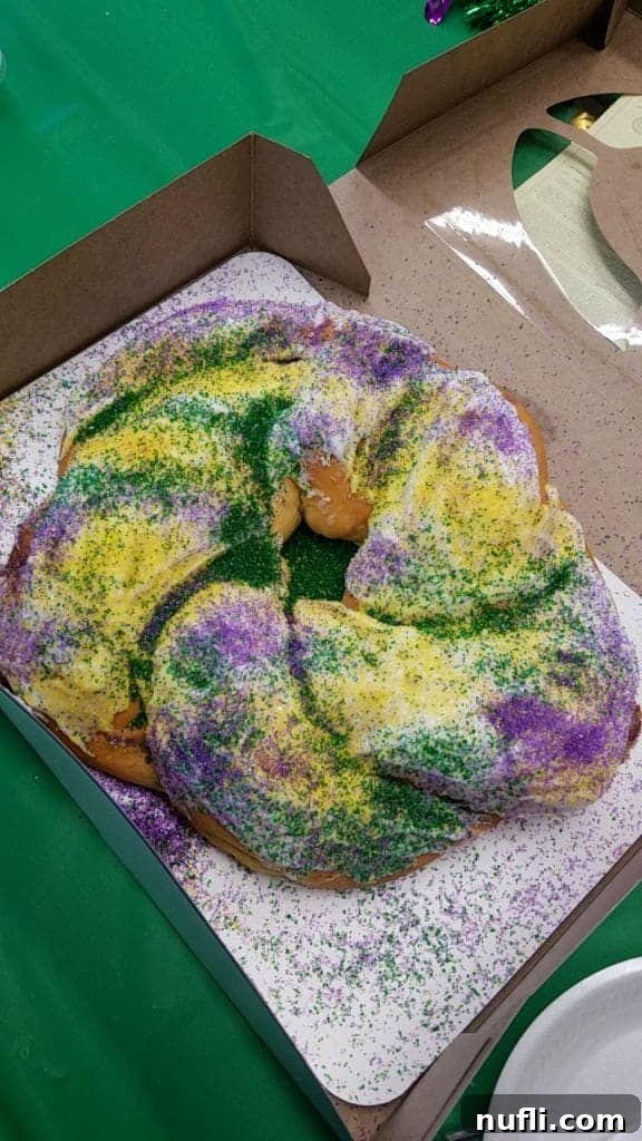 King cake in a box on a green tablecloth 