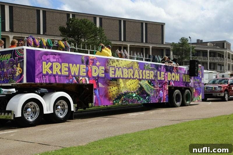 The colorful Krewe De Embrasser Le Bon Vie float, celebrating 'Embrace the Good Life,' brightens the Lake Charles parade route.