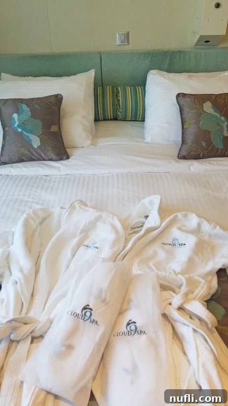 Cloud 9 spa robes and slippers neatly laid on the bed