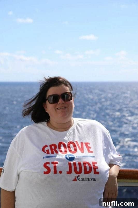 Tammilee wearing a Groove for St. Jude shirt with the ocean behind her