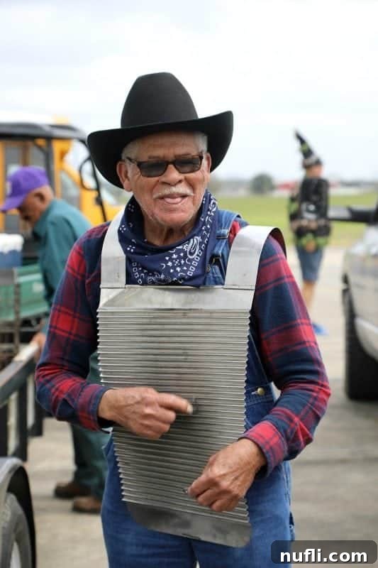 A musician playing a metal washboard with gusto, wearing a cowboy hat, a quintessential image of Zydeco music at the Chicken Run.