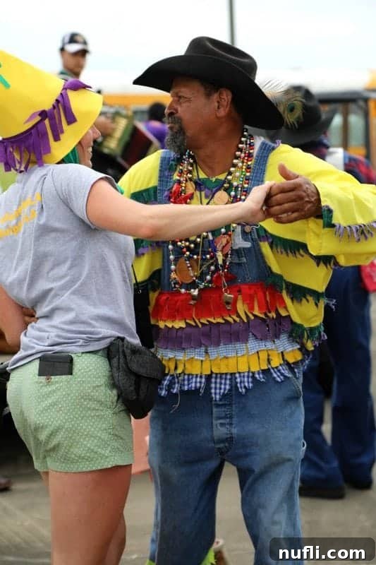 A man in a cowboy hat dancing spiritedly with a woman in a yellow hat, their joy infectious amidst the Mardi Gras revelry.