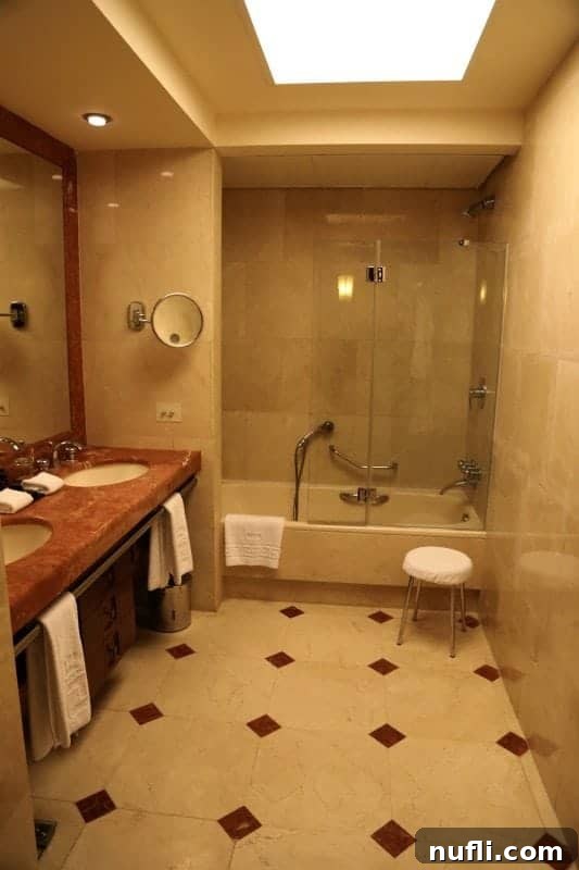 Bathroom in the King David with shower/tub and two sinks 