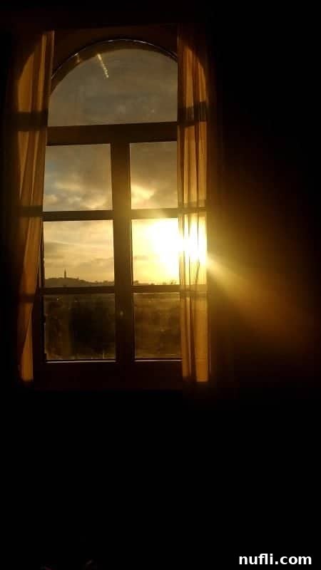 Light streaming into the window of the hotel room 
