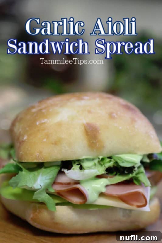 Garlic Aioli Ham and Swiss Ciabatta 2 Close-up of a Ham and Swiss Ciabatta Sandwich with Garlic Aioli spread, on a wooden board.