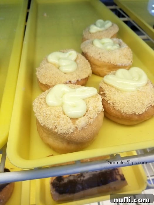A tray filled with vibrant key lime donuts, showcasing a unique citrus-flavored twist on a classic treat.