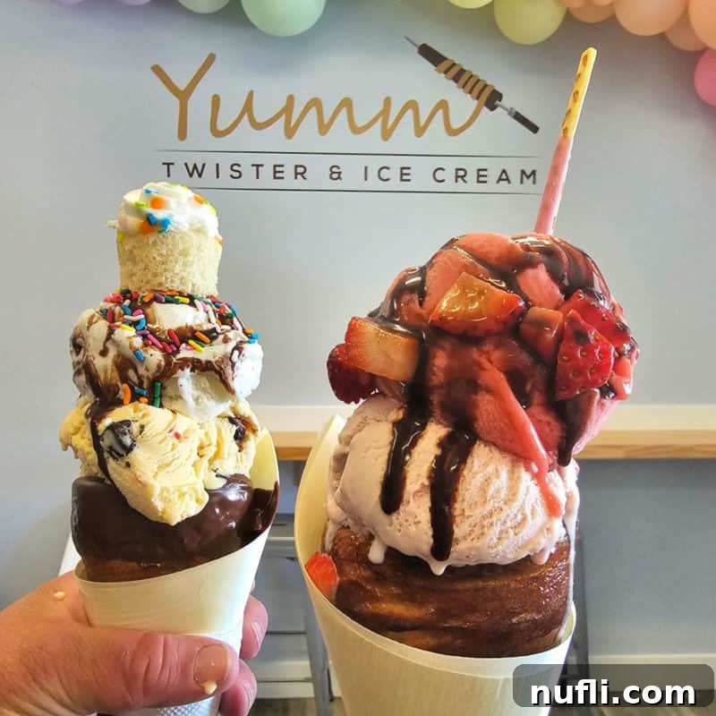 Two whimsical Yumm Twister ice cream cones, each a towering spiral of soft-serve gelato with various toppings and drizzles, showcasing a unique European-inspired dessert.