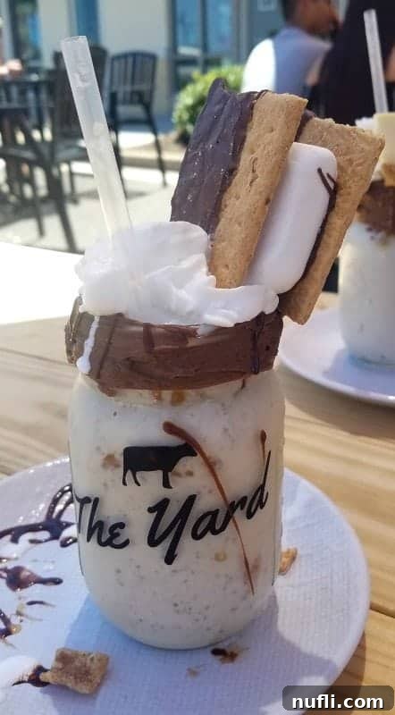Best Things to Do in Orange Beach and Gulf Shores Alabama 12 An indulgent Yard Milkshake, topped with a delectable s'mores, showcasing a sweet treat from Gulf Shores.