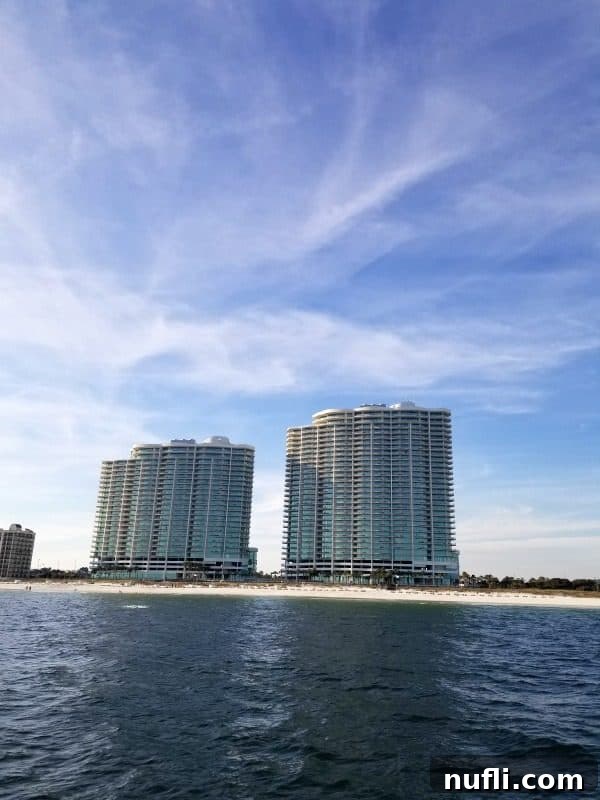 Best Things to Do in Orange Beach and Gulf Shores Alabama 23 The stunning Turquoise Place condo building, as seen from the tranquil waters of the Gulf, showcasing its luxurious beachside presence.