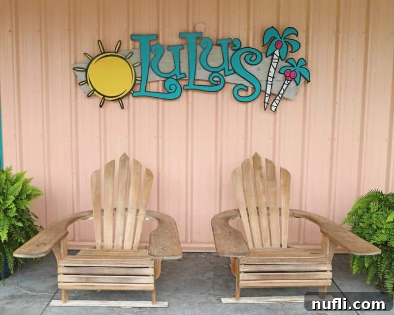 Best Things to Do in Orange Beach and Gulf Shores Alabama 10 The iconic LuLu's sign, welcoming visitors, stands above two inviting Adirondack chairs, promising a relaxing and fun experience.