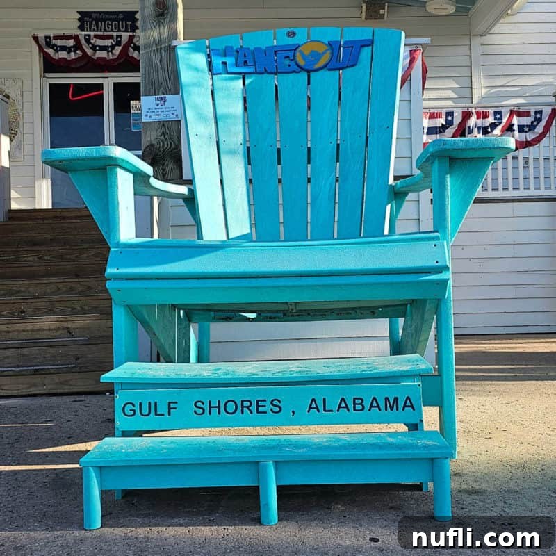 Orange Beach and Gulf Shores Must Try Restaurants 12 Blue Adirondack chair with The Hangout Gulf Shores, Alabama printed on it