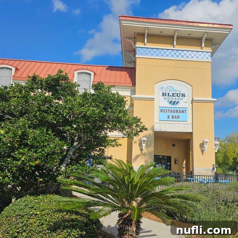 Orange Beach and Gulf Shores Must Try Restaurants 26 Exterior of Bleus Burger restaurant with palm trees and clouds