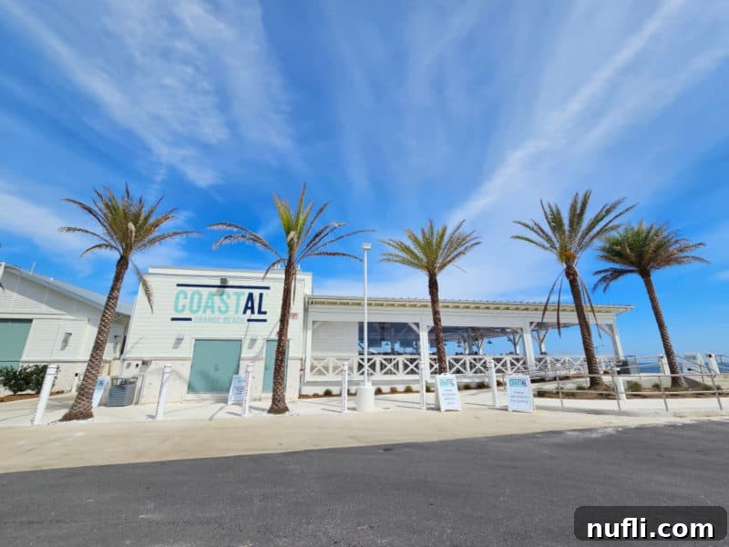 Orange Beach and Gulf Shores Must Try Restaurants 28 CoastAL Restaurant exterior with palm trees and blue skies