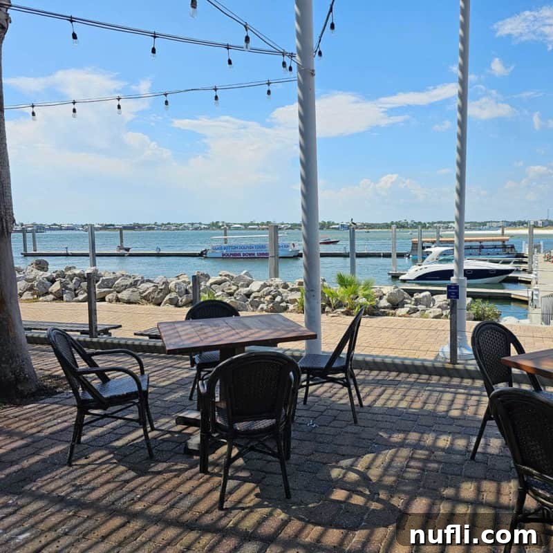 Orange Beach and Gulf Shores Must Try Restaurants 29 outdoor tables and chairs with a view of the water and boats at Cobalt