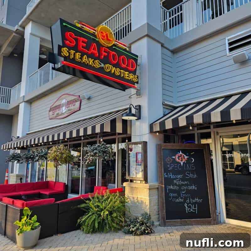 Orange Beach and Gulf Shores Must Try Restaurants 31 Seafood steaks and Oyster sign above Ginny Lane restaurant entrance door