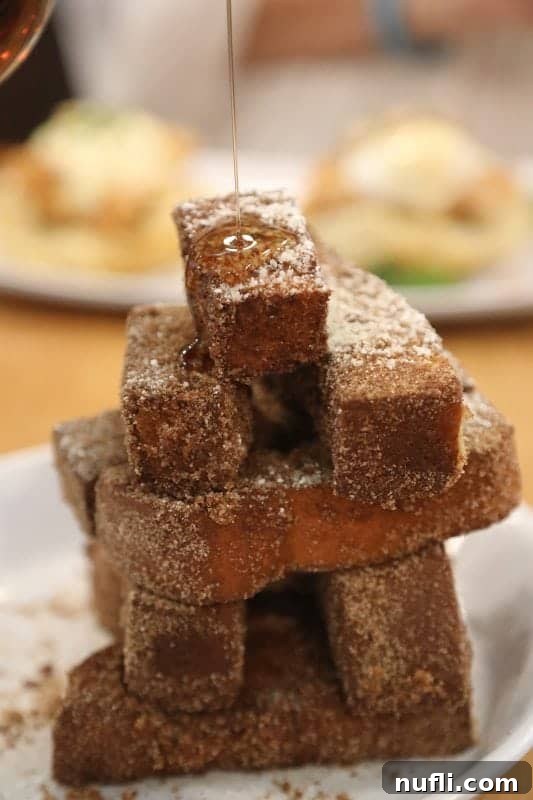 Orange Beach and Gulf Shores Must Try Restaurants 37 French toast sticks with syrup pouring over them.