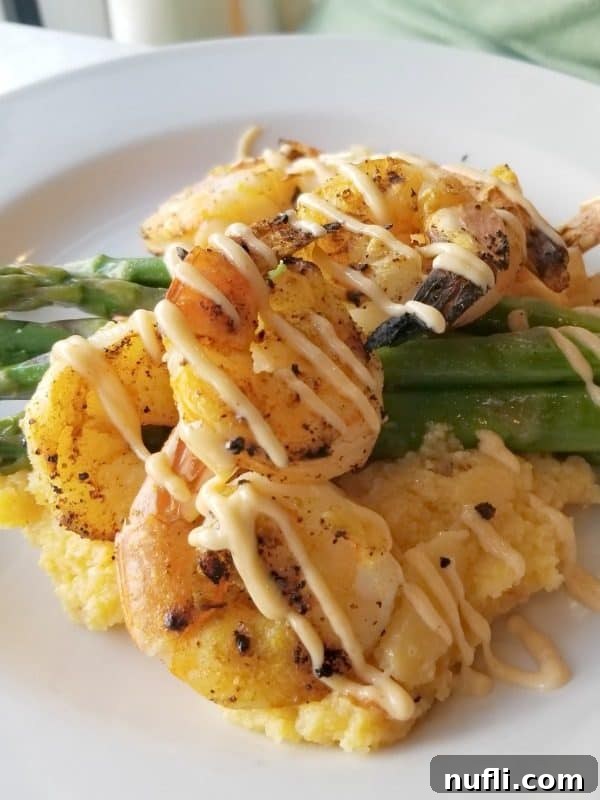 Orange Beach and Gulf Shores Must Try Restaurants 47 Shrimp covered in sauce over asparagus