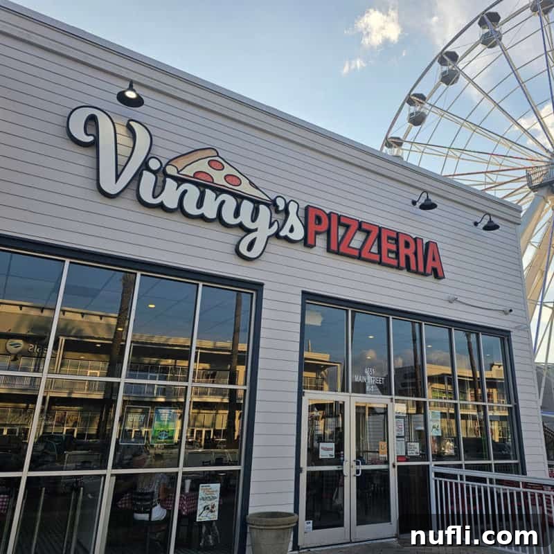 Orange Beach and Gulf Shores Must Try Restaurants 52 Vinny's Pizzeria entrance with The Wharf Ferris Wheel in the background
