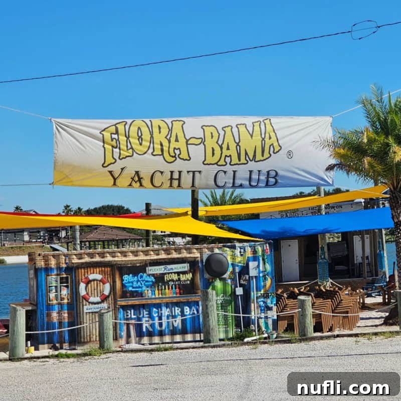 Orange Beach and Gulf Shores Must Try Restaurants 54 Flora Bama Yacht Club Sign over a Blue Chair Bay Rum Bar sign