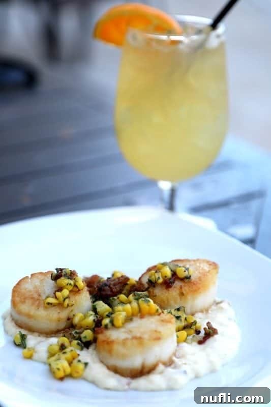 Orange Beach and Gulf Shores Must Try Restaurants 57 scallops over risotto next to a cocktail