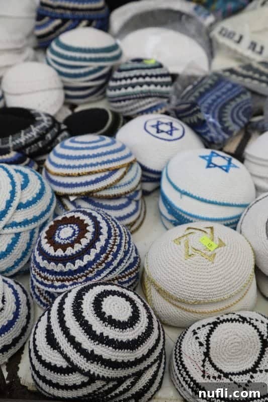 Mahane Yehuda Market Jerusalem's Culinary Soul 12 Colorful Jewish kippot (caps) meticulously arranged on display for sale