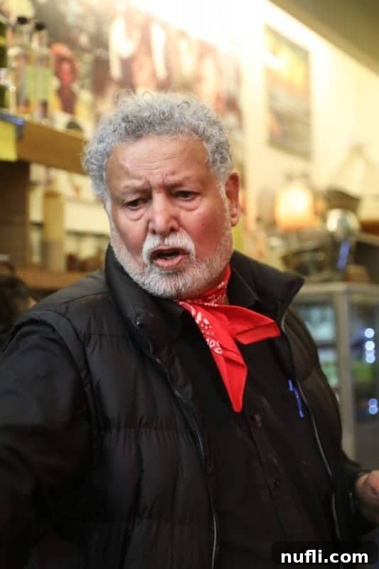 Mahane Yehuda Market Jerusalem's Culinary Soul 16 A gentleman engaging in conversation, wearing a distinctive red scarf