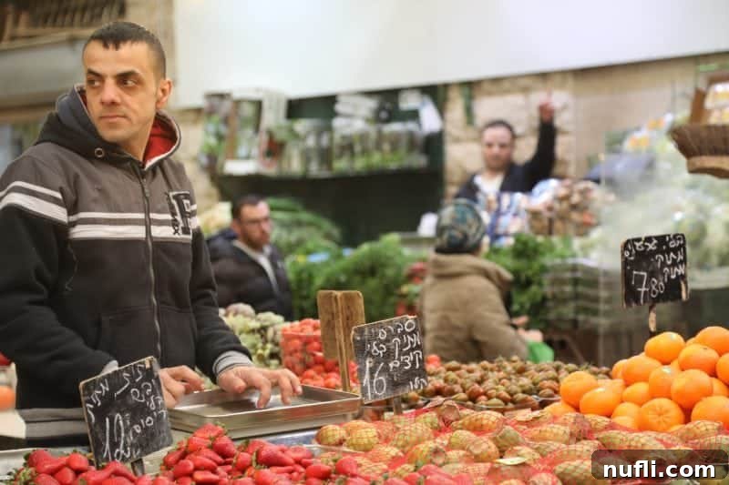 Mahane Yehuda Market Jerusalem's Culinary Soul 19 A man standing proudly next to a vibrant display of fresh fruits and nuts