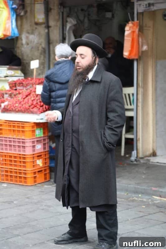 Mahane Yehuda Market Jerusalem's Culinary Soul 24 A man standing gracefully, wearing a traditional hat and long coat