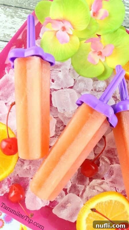 Bahama mama popsicles on a bed of ice with orange slices and cherries