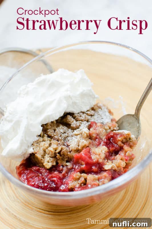 Crockpot strawberry crisp over a bowl with strawberry crisp topped with whipped cream and a spoon