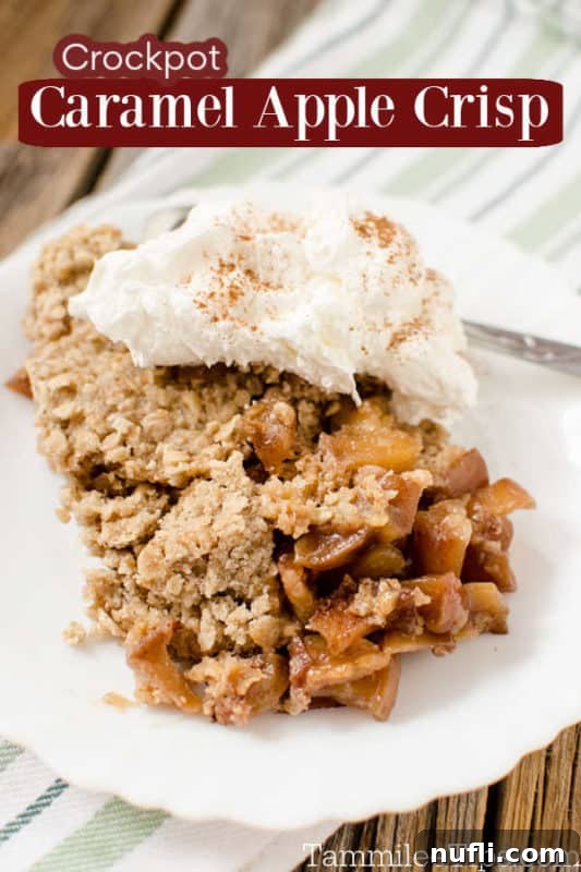 Decadent Crock Pot Caramel Apple Crisp 2 Crock Pot Caramel Apple Crisp served on a white plate with whipped cream, ready to enjoy.