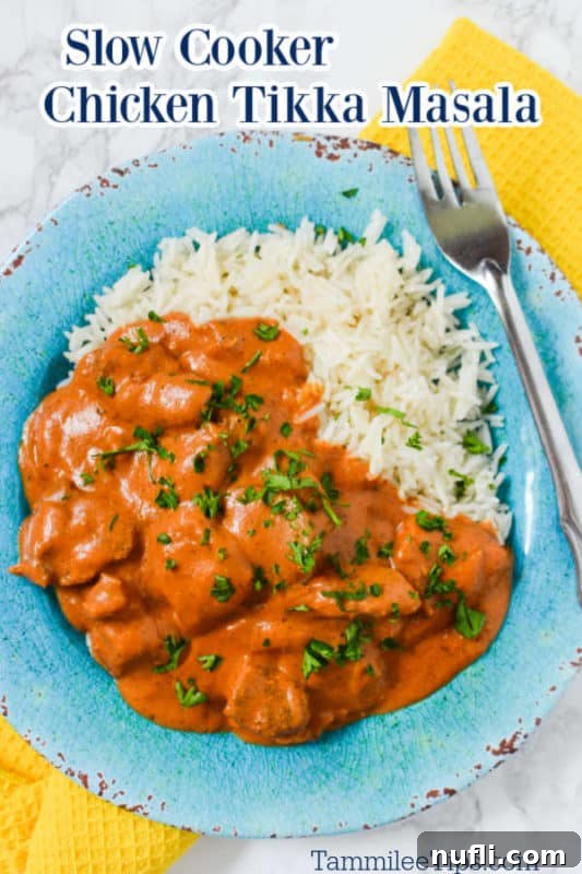 Slow Cooker Chicken Tikka Masala over a blue plate with chicken, white rice, and a fork