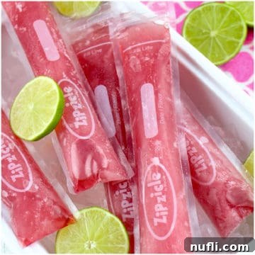 Pink popsicles in zipzicle bags on ice with limes