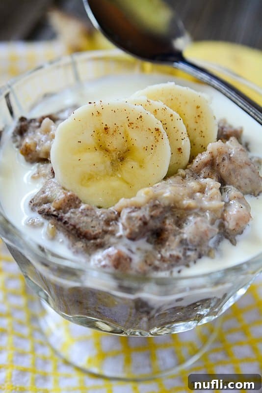 Bowl of Slow Cooker Banana Bread Oatmeal garnished with fresh banana slices, ready to be enjoyed as a wholesome breakfast.