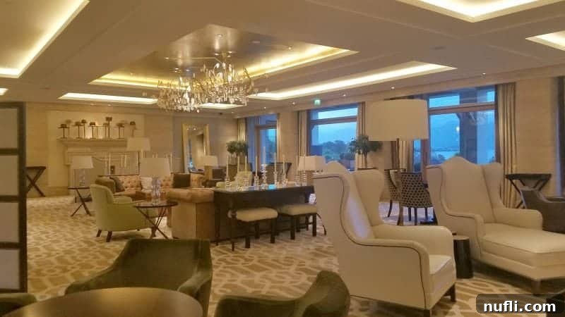 Lakeside Elegance in Killarney: The Europe Hotel 11 Spacious, bright white lobby area at The Europe Hotel Killarney, furnished with comfortable chairs and loungers.