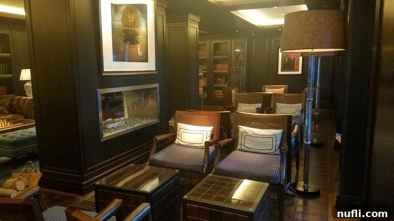 Lakeside Elegance in Killarney: The Europe Hotel 10 Inviting library lobby area at The Europe Hotel Killarney with comfortable chairs arranged around a warm fireplace.