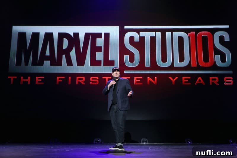 Kevin Feige on stage at D23 EXPO 2017, with a large Marvel Studios logo behind him, presenting Avengers: Infinity War.