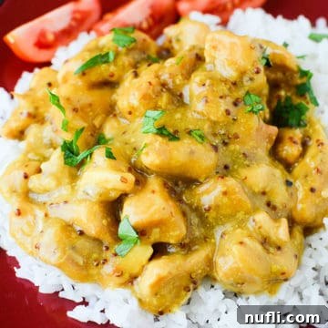 Honey Mustard chicken on a bed of white rice near tomato slices