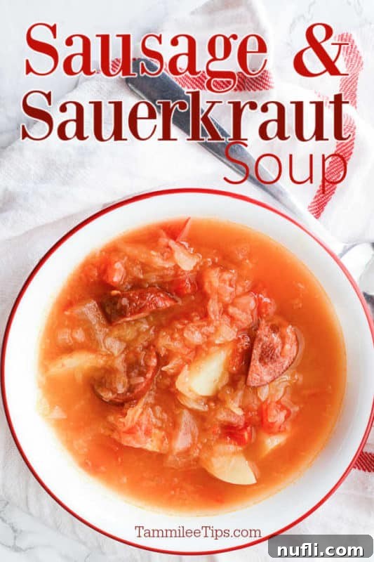 Sausage & Sauerkraut soup over a white bowl with soup on a cloth napkin